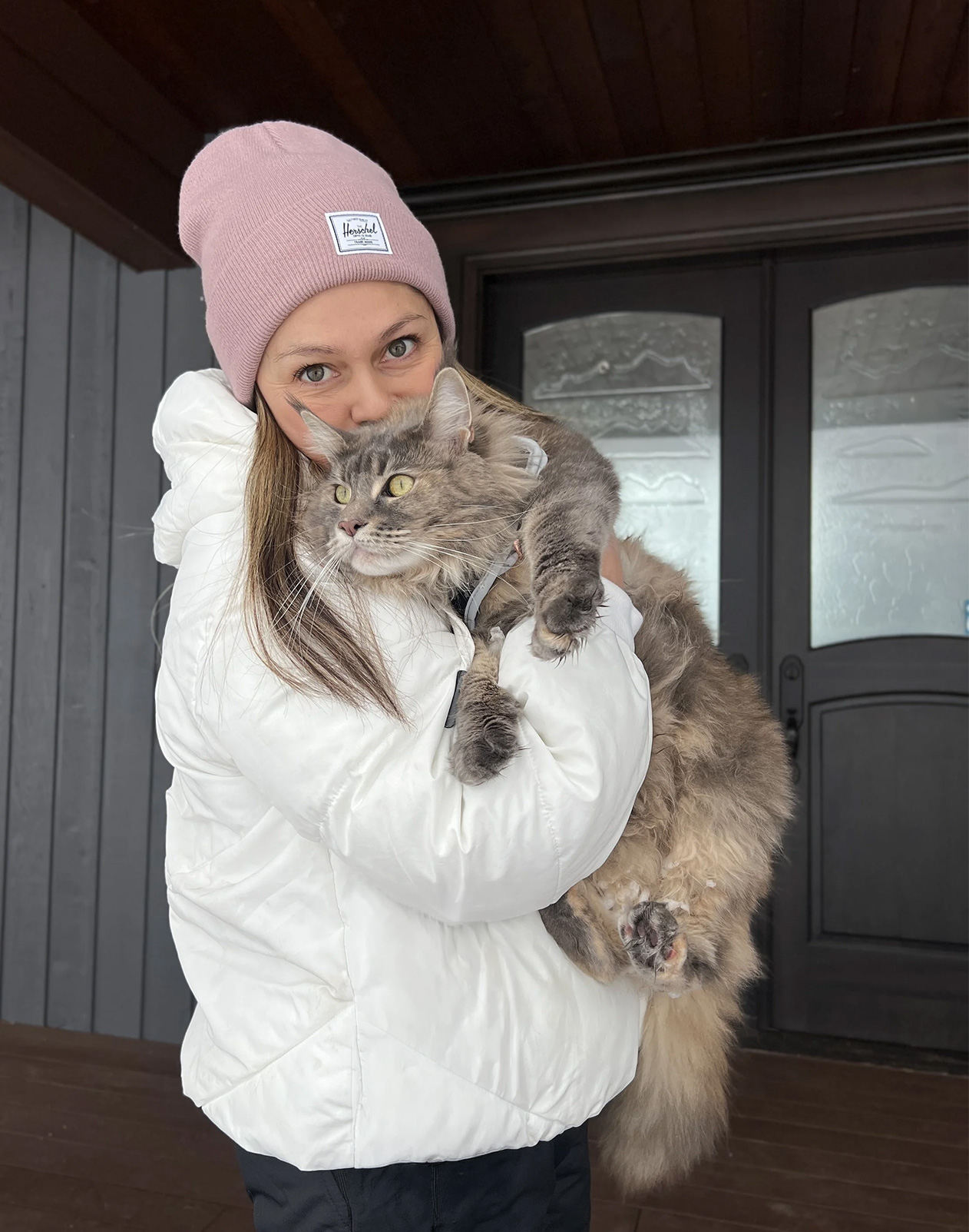 An Alley Cats Hotel team member welcoming a cat